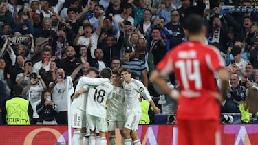 Real Madrid players celebrate their second goal scored by Real Madrid's Brazilian forward #07 Vinicius Junior during the UEFA Champions League knockout round play-off second leg football match between Real Madrid CF and SL Benfica at Santiago Bernabeu Stadium in Madrid on February 25, 2026. (Photo by Thomas COEX / AFP)