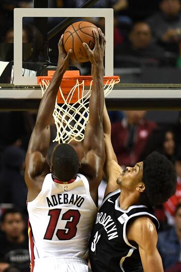 Brooklyn Nets' Jarrett Allen (R) tries to stop Miami Heat's Bam Adebayo from dunking the ball, during an NBA Global Games match at the Mexico City Arena, on December 9, 2017, in Mexico City. / AFP PHOTO / PEDRO PARDO