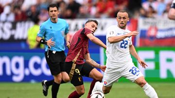 Slovakia's midfielder #22 Stanislav Lobotka (R) fights for the ball with Belgium's midfielder #09 Leandro Trossard (C)  during the UEFA Euro 2024 Group E football match between Belgium and Slovakia at the Frankfurt Arena in Frankfurt am Main on June 17, 2024. (Photo by Kirill KUDRYAVTSEV / AFP)