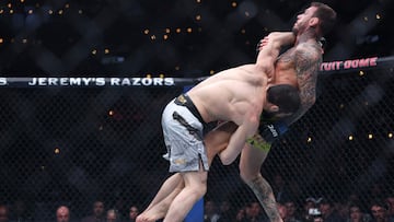 INGLEWOOD, CALIFORNIA - JANUARY 18: Islam Makhachev of Russia takes down Renato Moicano of Brazil in a lightweight title fight during UFC 311 at Intuit Dome on January 18, 2025 in Inglewood, California. Harry How/Getty Images/AFP (Photo by Harry How / GETTY IMAGES NORTH AMERICA / Getty Images via AFP)