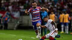 Fortaleza's forward Moises (L) and San Lorenzo's Colombian defender Rafael Perez vie for the ball during the Copa Sudamericana group stage second leg football match between Brazil's Fortaleza and Argentina's San Lorenzo, at the Arena Castelao stadium in Fortaleza, Brazil, on May 24, 2023. (Photo by Thiago Gadelha / AFP)