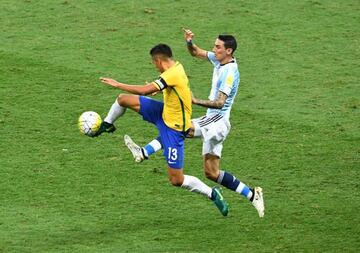 Di María (right) vies for the ball with Brazil's Marquinhos during Argentina's 3-0 defeat in Belo Horizonte.