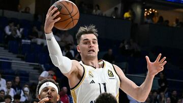Real Madrid's Croatian forward Mario Hezonja jumps for the ball during the NBA Preseason game between the Dallas Mavericks and Real Madrid Baloncesto at the Wizink centre in Madrid on October 10, 2023.