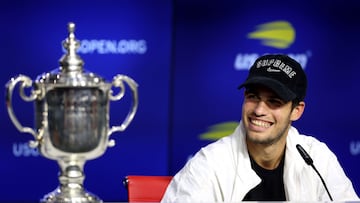 NEW YORK, NEW YORK - SEPTEMBER 11: Carlos Alcaraz of Spain looks at the championship trophy and smiles during a news conference after defeating Casper Ruud of Norway during their Men?s Singles Final match on Day Fourteen of the 2022 US Open at USTA Billie Jean King National Tennis Center on September 11, 2022 in the Flushing neighborhood of the Queens borough of New York City. Julian Finney/Getty Images/AFP