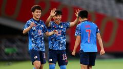 Tokyo 2020 Olympics - Soccer Football - Men - Group A - Japan v South Africa - Tokyo Stadium, Tokyo, Japan - July 22, 2021. Takefusa Kubo of Japan celebrates scoring their first goal with Ayase Ueda of Japan and Reo Hatate of Japan REUTERS/Edgar Su