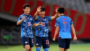 Tokyo 2020 Olympics - Soccer Football - Men - Group A - Japan v South Africa - Tokyo Stadium, Tokyo, Japan - July 22, 2021. Takefusa Kubo of Japan celebrates scoring their first goal with Ayase Ueda of Japan and Reo Hatate of Japan REUTERS/Edgar Su