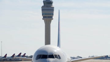 FILE PHOTO: Atlanta's air traffic control tower is seen behind a plane at Hartsfield-Jackson Atlanta International Airport, in Georgia, U.S. February 1, 2025. REUTERS/Megan Varner/File Photo