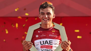 TOPSHOT - Championship first place winner UAE Team Emirates's Mexican rider Isaac Del Toro Romero celebrates on the podium after the seventh and final stage of the UAE Tour cycling event from Zayed National Museum to Abu Dhabi Breakwater in Abu Dhabi on February 22, 2026. (Photo by Fadel SENNA / AFP)