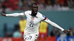 USA's forward #21 Timothy Weah celebrates scoring his team's first goal during the Qatar 2022 World Cup Group B football match between USA and Wales at the Ahmad Bin Ali Stadium in Al-Rayyan, west of Doha on November 21, 2022. (Photo by Jewel SAMAD / AFP)