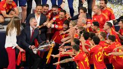 Spanish King Felipe VI holds the trophy as he and his daughter Princess Sofia celebrate with the players they won the final match between Spain and England at the Euro 2024 soccer tournament in Berlin, Germany, Sunday, July 14, 2024. (AP Photo/Andreea Alexandru)