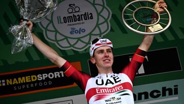 UAE Team Emirates team's Slovenian rider Tadej Pogacar celebrates on the podium after winning the 116th edition of the Giro di Lombardia (Tour of Lombardy), a 252,42 km cycling race from Bergamo to Como, in Como on October 8, 2022. (Photo by Marco BERTORELLO / AFP)