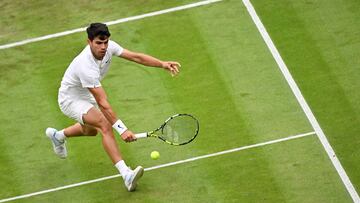 Spain's Carlos Alcaraz returns against Australia's Aleksander Vukic during their men's singles second round tennis match on the third day of the 2024 Wimbledon Championships at The All England Lawn Tennis and Croquet Club in Wimbledon, southwest London, on July 3, 2024. (Photo by ANDREJ ISAKOVIC / AFP) / RESTRICTED TO EDITORIAL USE