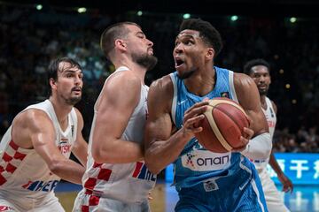 Greece�s Giannis Antetokounmpo (R) is marked by Croatia�s Ivica Zubak (C) during the 2024 FIBA Olympic Qualifying Tournament semi-final basketball match between Greece and Croatia at the Peace and Friendship Stadium in Athens, on July 7, 2024. (Photo by Aris MESSINIS / AFP)