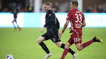 D.C. United forward Wayne Rooney (9) chases the ball in front of New York Red Bulls midfielder Aaron Long (33) during the second half of an MLS soccer match Wednesday, July 25, 2018, in Washington. The Red Bulls won 1-0. (AP Photo/Nick Wass)