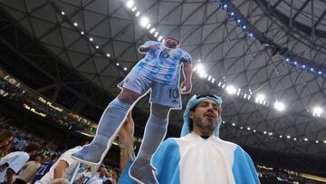 LUSAIL CITY, QATAR - DECEMBER 18: An Argentina fan with a cardboard cut out of Lionel Messi of Argentina shows his support prior to the FIFA World Cup Qatar 2022 Final match between Argentina and France at Lusail Stadium on December 18, 2022 in Lusail City, Qatar. (Photo by Marc Atkins/Getty Images)