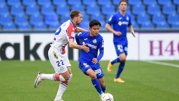 GETAFE, SPAIN - JANUARY 31: Takefusa Kubo of Getafe CF is challenged by Florian Lejeune of Deportivo Alaves during the La Liga Santander match between Getafe CF and Deportivo Alaves at Coliseum Alfonso Perez on January 31, 2021 in Getafe, Spain. Sporting