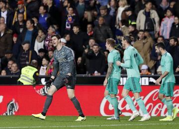 Real Madrid players celebrate of Benzema's late equaliser against Valencia.