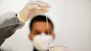 A medical worker holds a test tube after administering a nasal swab to a patient at a coronavirus disease (COVID-19) testing center in Nice, France, November 23, 2021.   REUTERS/Eric Gaillard