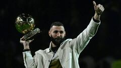 Real Madrid's French forward Karim Benzema poses on the pitch with his Ballon d'Or trophy at half time of the French L1 football match between Olympique Lyonnais (OL) and OGC Nice at The Groupama Stadium in Decines-Charpieu, central-eastern France, on November 11, 2022. (Photo by OLIVIER CHASSIGNOLE / AFP) (Photo by OLIVIER CHASSIGNOLE/AFP via Getty Images)