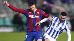 CORDOBA, SPAIN - JANUARY 13: Clement Lenglet of Barcelona battles for possession with Mikel Merino of Real Sociedad  during the Supercopa de Espana Semi Final match between Real Sociedad and FC Barcelona at Estadio Nuevo Arcangel on January 13, 2021 in Co