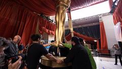 Workers load in a large Oscar statue as preparations continue for the 95th Academy Awards.
