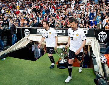 Rubén Baraja y David Albelda salen al campo el trofeo de la Liga.