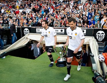 Rubén Baraja y David Albelda salen al campo el trofeo de la Liga.