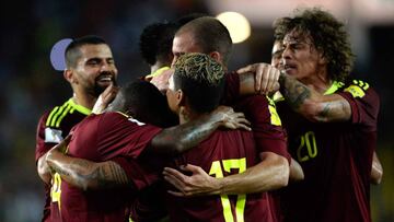 Venezuela players celebrate after scoring against Peru during their 2018 FIFA World Cup qualifier football match in Maturin, Venezuela, on March 23, 2017. / AFP PHOTO / FEDERICO PARRA