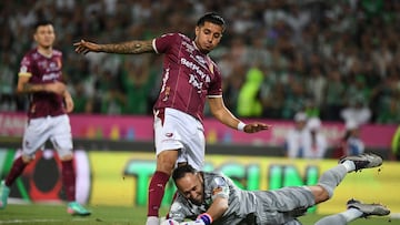 Nacional's goalkeeper #01 David Ospina and Tolima's midfielder #10 Yeison Guzman fight for the ball during the Colombian League second leg football final match between Atletico Nacional and Deportes Tolima at the Atanasio Girardot Stadium in Medellin, Colombia on December 22, 2024. (Photo by Jaime SALDARRIAGA / AFP)