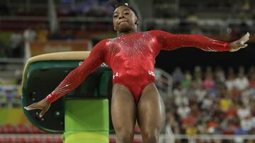 Simone Biles clava su ejercicio de salto.