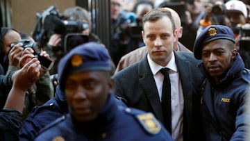 FILE PHOTO: FILE PHOTO: Oscar Pistorius is escorted by police officers as he arrives for his sentencing for the 2013 murder of his girlfriend Reeva Steenkamp, at North Gauteng High Court in Pretoria, South Africa July 6, 2016. REUTERS/Siphiwe Sibeko/File Photo