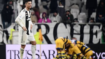 Juventus' Portuguese forward Cristiano Ronaldo (L) reacts after Parma scored a last second equalizer and its players celebrate (Rear) during the Italian Serie A football match Juventus vs Parma on February 2, 2019 at the Juventus stadium in Turin. (P