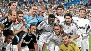 <b>CAMPEONES. </b>Varios jugadores del Real Madrid posan con su 19º Trofeo Bernabéu. Otros futbolistas del equipo hacían ejercicios de estiramiento en el campo.