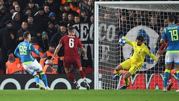 Liverpool&#039;s Brazilian goalkeeper Alisson Becker (2R) saves a shot from Napoli&#039;s Polish striker Arkadiusz Milik (L) during the UEFA Champions League group C football match between Liverpool and Napoli at Anfield stadium in Liverpool, north west E