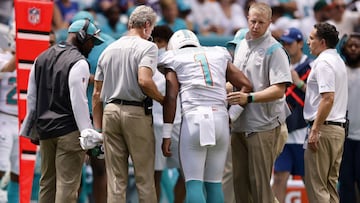 MIAMI GARDENS, FLORIDA - SEPTEMBER 19: Quarterback Tua Tagovailoa #1 of the Miami Dolphins is helped off the field in the first half of the game against the Buffalo Bills at Hard Rock Stadium on September 19, 2021 in Miami Gardens, Florida.   Michael Reav