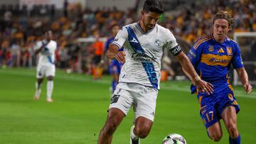 Jul 31, 2024; Houston, Texas, USA; Puebla midfielder Pablo Gonzalez (6) dribbles against Tigres UANL midfielder Sebastian Cordova (17) in the second half at Shell Energy Stadium. Mandatory Credit: Thomas Shea-USA TODAY Sports