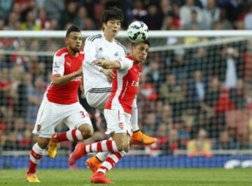 Arsenal's Alexis Sanchez, right, shields the ball from Swansea City\x92s Ki Sung-Yueng during their English Premier League soccer match between Arsenal and Swansea City at the Emirates stadium in London, Monday May 11, 2015. (AP Photo/Alastair Grant)