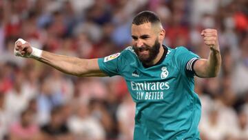 Real Madrid's French forward Karim Benzema celebrates after Real Madrid's Spanish defender Nacho Fernandez scored a goal during the Spanish League football match between Sevilla FC and Real Madrid CF at the Ramon Sanchez Pizjuan stadium in Sevil