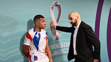 AL KHOR, QATAR - DECEMBER 14: Kylian Mbappe of France speaks with Walid Regragui, Head Coach of Morocco, in the tunnel after the FIFA World Cup Qatar 2022 semi final match between France and Morocco at Al Bayt Stadium on December 14, 2022 in Al Khor, Qatar. (Photo by Michael Regan - FIFA/FIFA via Getty Images)