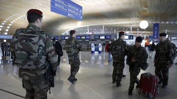 French soldiers patrol inside Charles de Gaulle International Airport.