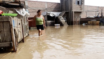 A resident observes her flooded patio, in the aftermath of the Moche river overflowing due to torrential rains caused by Cyclone Yaku, in Trujillo, Peru, March 13, 2023. REUTERS/Randy Reyes NO RESALES. NO ARCHIVES