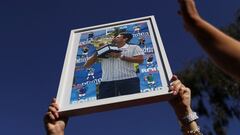 A supporter of Serbian tennis player Novak Djokovic holds his photo during a rally outside the Park Hotel, where the star athlete is believed to be held while he stays in Australia, in Melbourne, Australia, January 9, 2022.  REUTERS/Loren Elliott