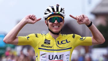 UAE Team Emirates XRG's Slovenian rider Tadej Poga?ar wearing the overall leader's yellow jersey celebrates as he crosses the finish line to win the 7th stage of the 77th edition of the Criterium du Dauphine cycling race, 131,6 km between Grand-Aigueblanche and Valmeinier, on June 14, 2025. (Photo by Anne-Christine POUJOULAT / AFP)