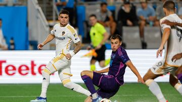 May 18, 2024; Charlotte, North Carolina, USA; Charlotte FC midfielder Andrew Privett (34) slides to stop a pass to Los Angeles Galaxy forward Gabriel Pec (11) during the second half at Bank of America Stadium. Mandatory Credit: Nell Redmond-USA TODAY Sports