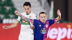 ELCHE, SPAIN - APRIL 21: Pere Milla of Elche CF (L) competes for the ball with Roque Mesa of Real Valladolid CF (R) during the La Liga Santander match between Elche CF and Real Valladolid CF at Estadio Martinez Valero on April 21, 2021 in Elche, Spain. Sp