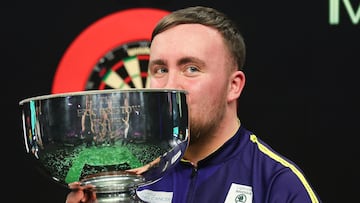 El jugador inglés de dardos Luke Littler posa con el trofeo de campeón del Grand Slam de Dardos 2024