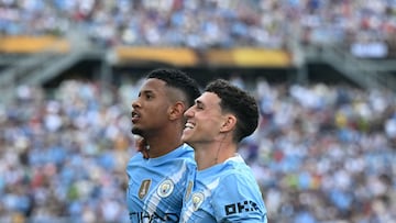 Manchester City's English midfielder #47 Phil Foden (R) celebrates with teammate Brazilian midfielder #26 Savinho after scoring his team's fourth goal during the FIFA Club World Cup 2025 Group D football match between Italy's Juventus and England's Manchester City at the Camping World stadium in Orlando on June 26, 2025. (Photo by Chandan KHANNA / AFP)