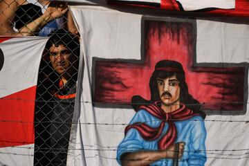 A River Plate's supporter looks on next to a flag with an image of folk Gauchito Gil saint during the Superliga first division tournament derby match against Boca Juniors at Monumental stadium in Buenos Aires, Argentina, on November 5, 