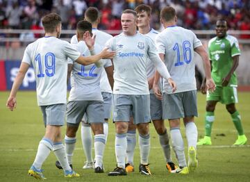 Wayne Rooney is congratulated by team-mates after scoring the opening goal.