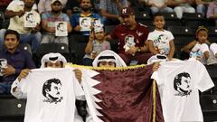 Football Soccer - Qatar v South Korea - World Cup 2018 Qualifiers - Doha, Qatar - 13/6/17- Fans hold t-shirts with pictures depicting Qatar&acirc;s Emir Sheikh Tamim Bin Hamad Al-Thani . The t-shirts read: &quot;Tamim is the glory.&quot; REUTERS/Ibrahee